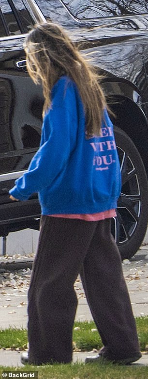 She also sported a pink shirt beneath, baggy grey PJs and Crocs