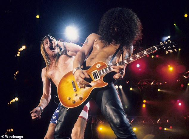 Pictured with frontman Axl Rose (L) in 1991