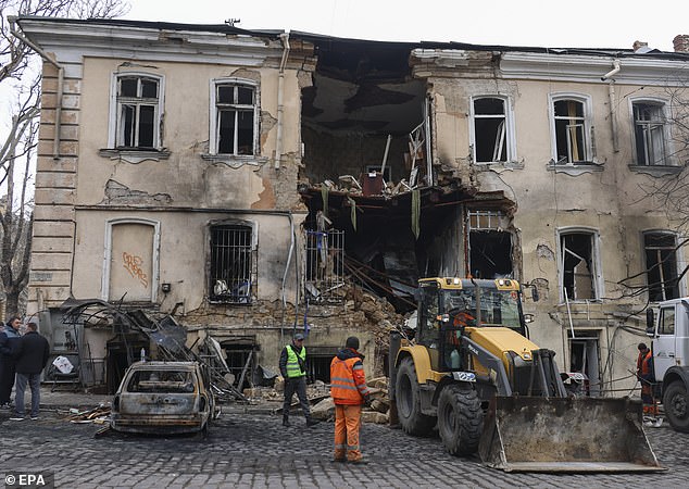 Communal workers at the scene of a Russian drone strike on a residential area in Odesa, Ukraine, March 19 2026, amid the ongoing Russian invasion