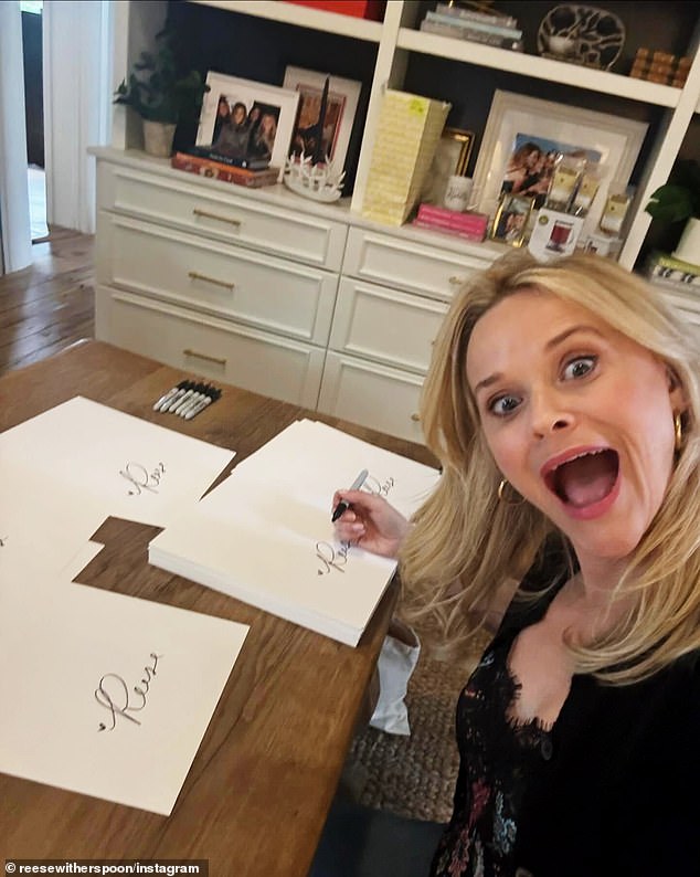 Even while busy at work, as seen in a photo of herself signing a large stack of papers, she showed how she stays in high spirits by taking a bright-eyed, fun selfie