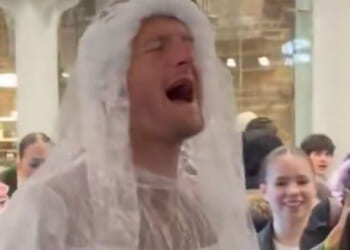 Fans declare 'one of our own' as Premier League star spotted singing in a WEDDING DRESS at train station