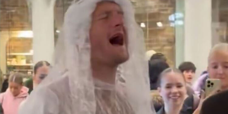 Fans declare 'one of our own' as Premier League star spotted singing in a WEDDING DRESS at train station