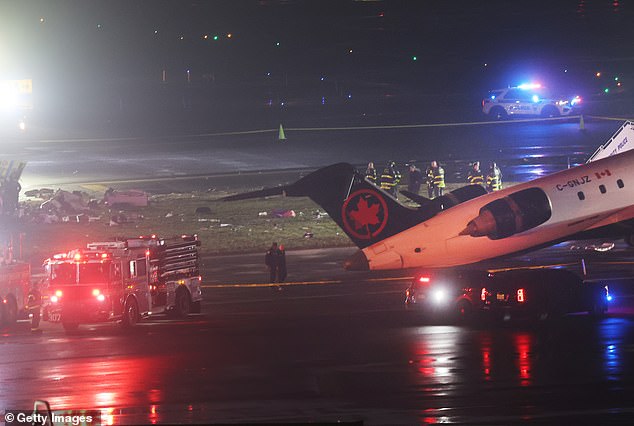 The Port Authority vehicle was responding to a separate incident when the crash occurred. The Air Canada plane is pictured above on the tarmac in the aftermath of the collision
