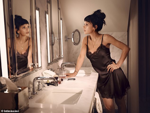 She swapped her two-piece styles for a chocolate brown silk nightie with a lace trim, which she wore while posing in a bathroom