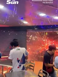 Terrifying moment fireworks stall explodes, sending pyrotechnics into restaurant