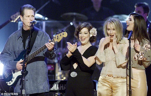 Brian Wilson (L) performs with his daughters Carnie (2nd-L) Wendy (R) and China Phillips (C) of Wilson Phillips during the conclusion of an all-star tribute concert for the former Beach Boys great at New York's Radio City Music Hall in 2001