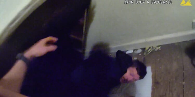 Moment cowering burglar is found hiding underneath a bed as he's arrested after breaking into home