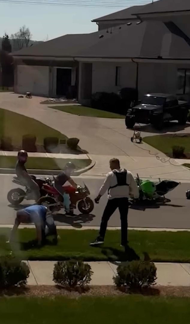 Two people on motorcycles looked on during the intense fight