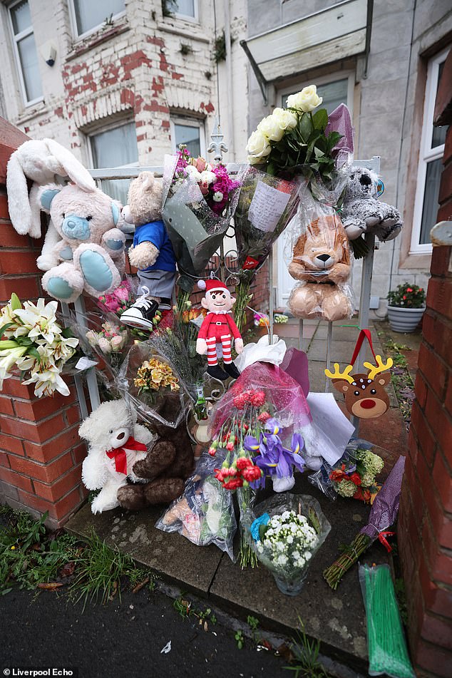 Tributes pictured outside the couple's house on Percy Road, Wirral, in the days after baby Miguel had been murdered