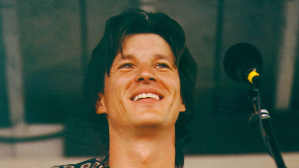 Ronnie Bowman smiling at a microphone.