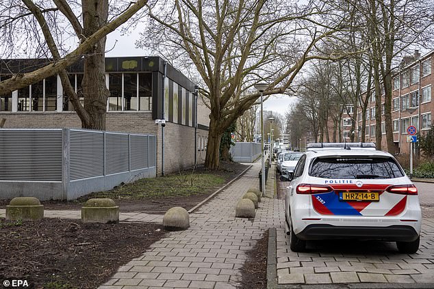 A police car parked outside a Jewish school in teh Netherlands following an explosion