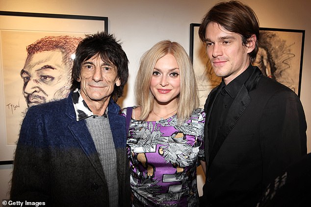 Jesse was born into rock royalty as the son of Rolling Stone Ronnie Wood who is worth £100million. (pictured with his father and his ex Fearne in 2011)