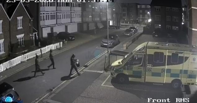 Three hooded suspects were seen approaching the emergency vehicles before they were set alight