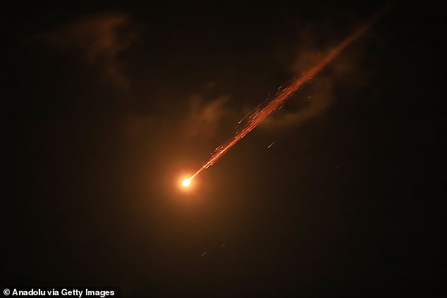 Missiles fired from Iran toward Israel are seen in the skies over Hebron, West Bank on March 24, 2026
