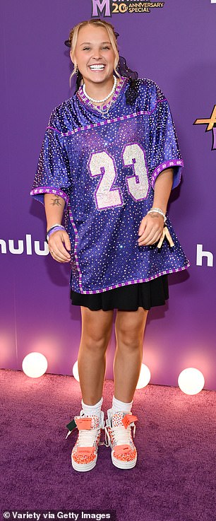 JoJo Siwa, 22, showed off her unique style in a bedazzled jersey paired with a black skirt and peach sneakers
