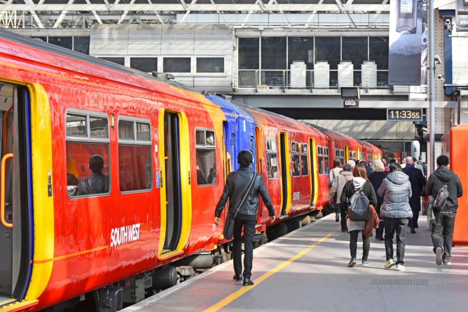 Commuters exiting a South West Trains service at London Waterloo station.