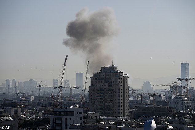 Smoke billows following an Iranian missile strike in Tel Aviv this morning