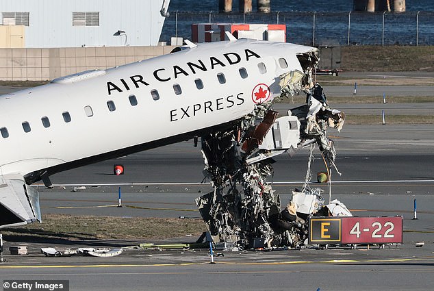 An Air Canada Express CRJ-900 sits on the runway on Tuesday after colliding with a Port Authority fire truck at LaGuardia Airport in New York City late Sunday night