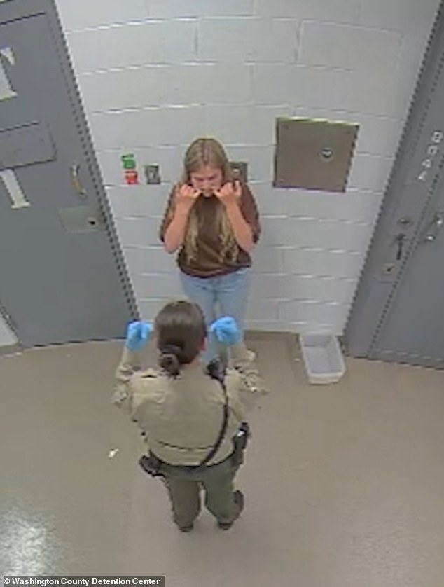 She had to show the officer her mouth as she stood against a wall