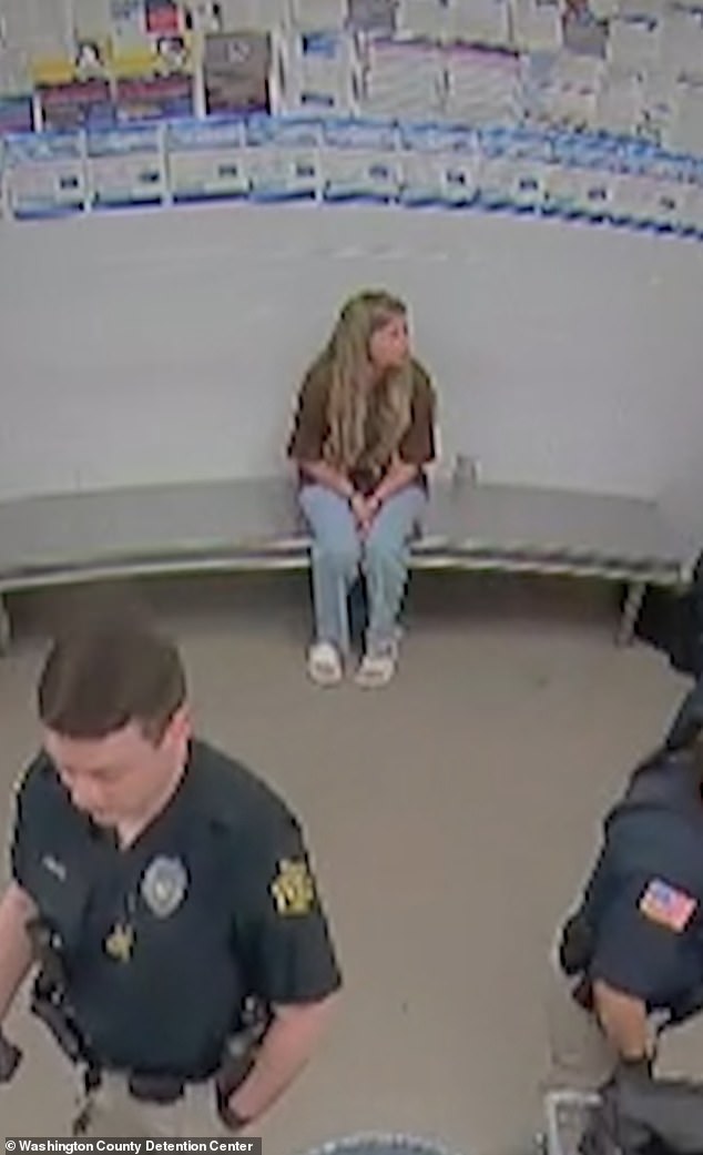 Kendra cut a lone figure as she sat by herself for a while with officers in front of her