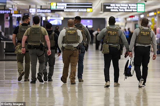 Immigration and Customs Enforcement (ICE) agents patrol Dulles International Airport on March 24, 2026 in Dulles, Virginia