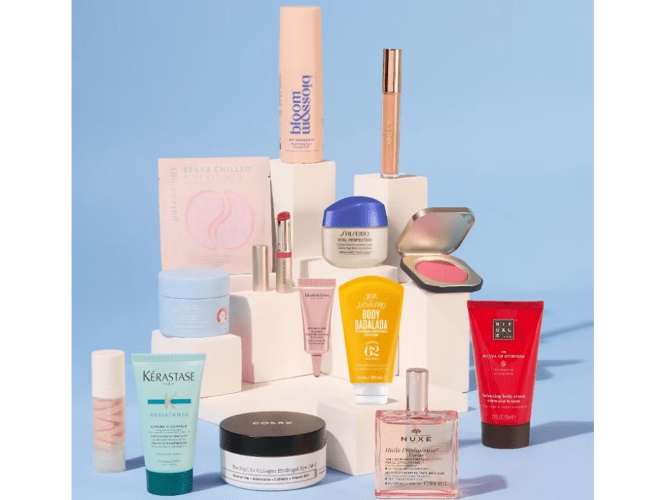 A collection of cosmetics and skincare products, including moisturizers, lotions, serums, eye gels, and makeup, arranged on white blocks.