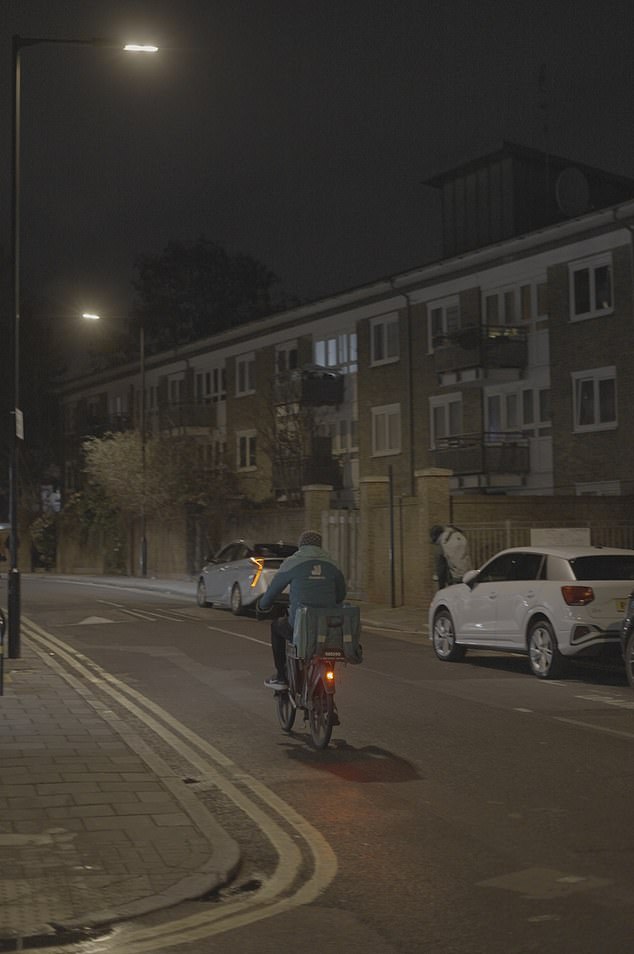 There is a bitter irony about ordering a Friday night takeaway treat when chances are the person delivering it will queue for their own food in a soup kitchen. Pictured: A food delivery rider