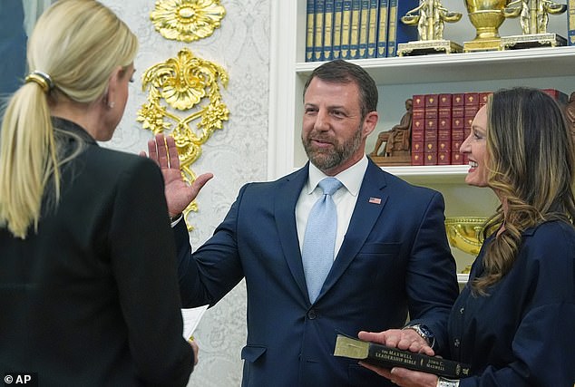 Attorney General Pam Bondi swore in Mullin as the new Secretary's wife, Christie Mullin, held a Bible