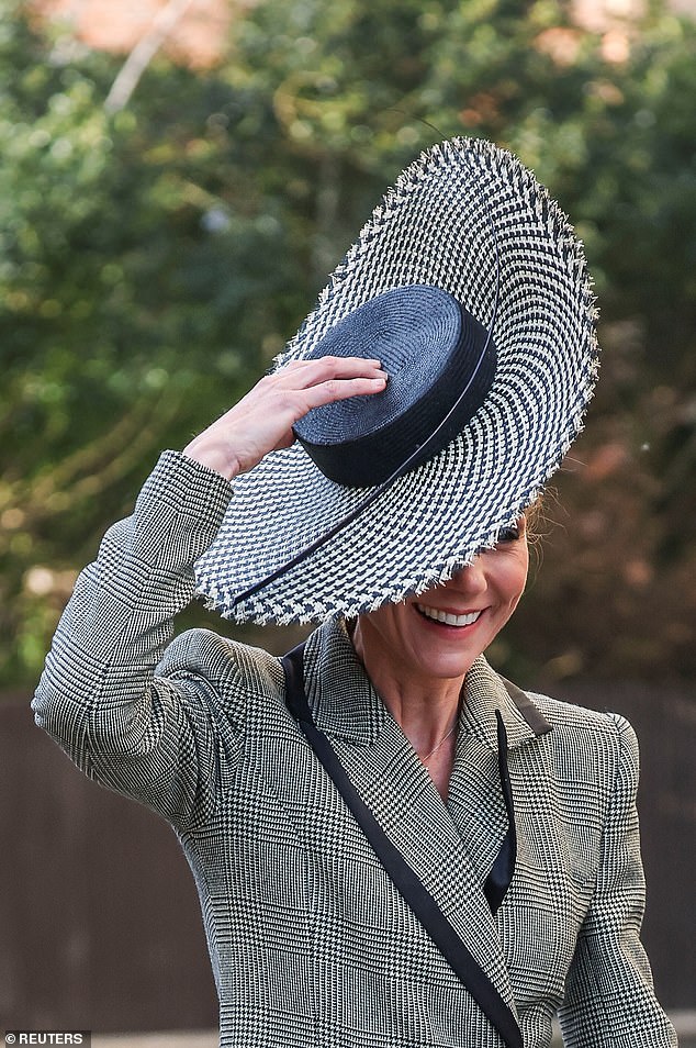 The Princess of Wales had to hold her hat again when she left the cathedral as the wind almost lifted it off her head