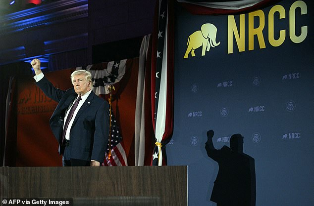 President Donald Trump raises a fist as he appears at the National Republican Congressional Committee's annual President's Dinner at Union Station on Wednesday night in Washington, D.C.