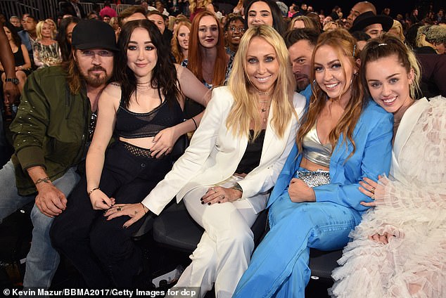 Tish split with Billy Ray back in 2022 after nearly 30 years of marriage, and last June Miley teased the whole family went through a, 'really difficult, dark decade' (Billy, Noah, Tish, Brandi and Miley L-R in 2017)