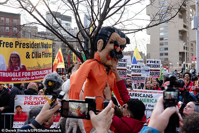 An effigy with the likeness of ousted Venezuelan president is hung from a tree outside the courthouse ahead of Thursday's pre-trial hearing