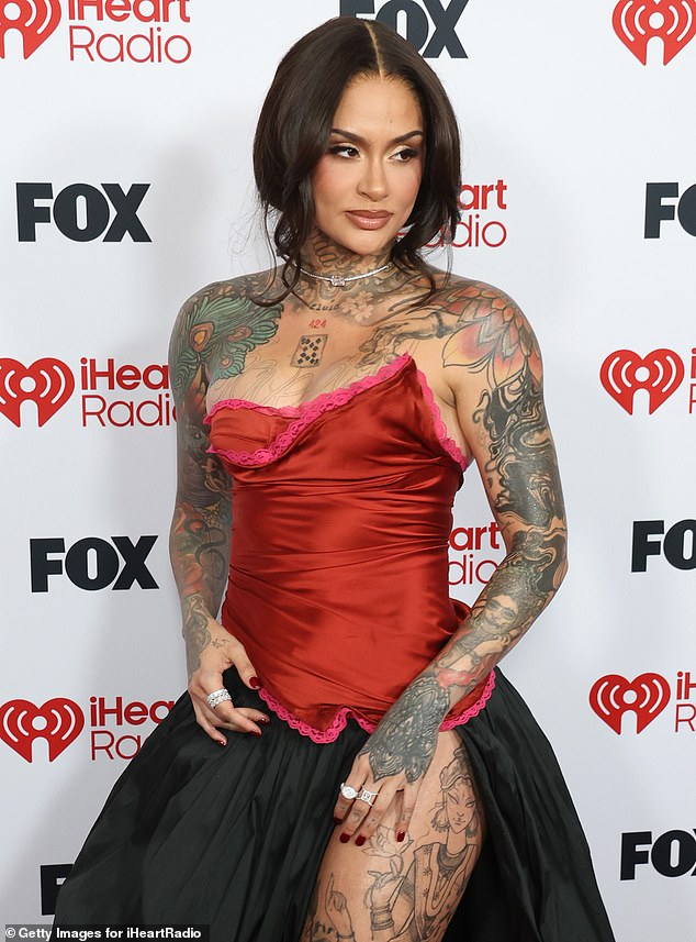 The eye-catching frock featured a red corset bodice and a billowing black skirt with a daring slit up one leg