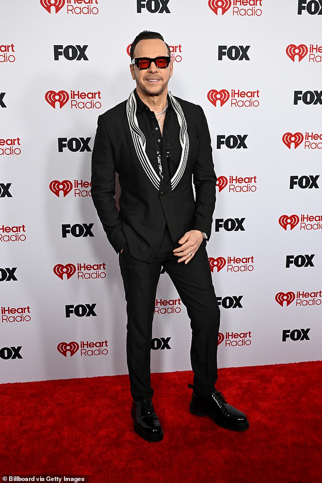 McCarthy was joined by her pop star husband Donnie Wahlberg, 56, who walked the red carpet separately in a stylish black dress shirt and skinny slacks