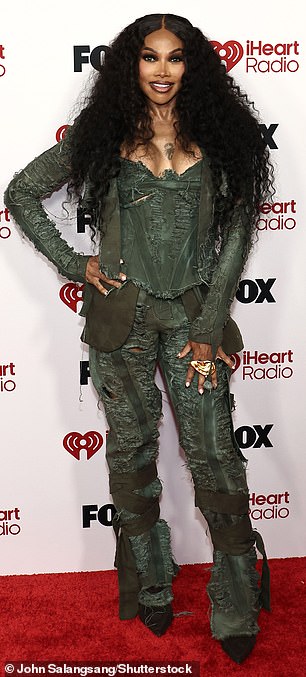 The iconic hip-hop group posed up in coordinating dark green looks, all of which featured busty corsets; Sandra Denton pictured