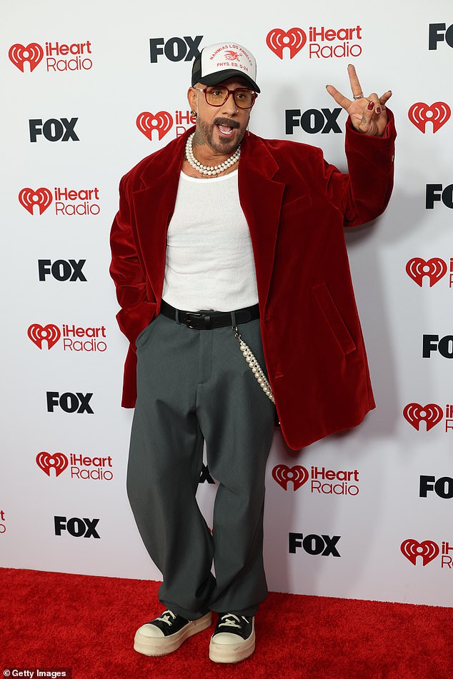 NSYNC star AJ McLean flashed a peace sign as he arrived to the annual awards ceremony in a fuzzy red coat, baggy trousers and platform high-top sneakers