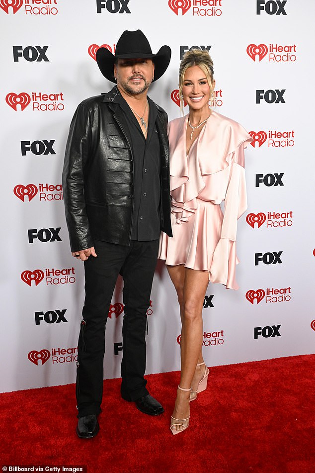 Country crooner Jason Aldean, 49, rocked his cowboy hat and an edgy all-black outfit as he wrapped an arm around much-younger wife Brittany Aldean, 37