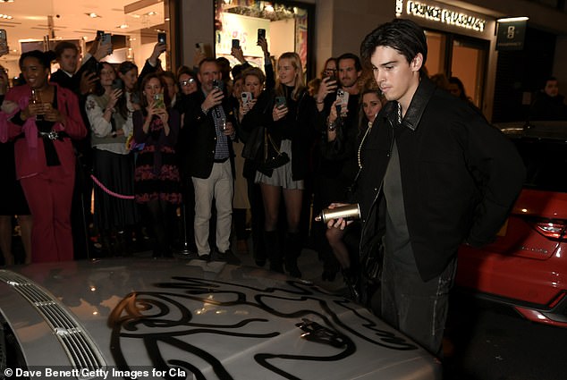 The talented artist gave a BMW the spray paint treatment at his exhibition debut