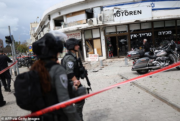 Despite nearly four weeks of constant bombardment and the decapitation of its government, Iran is still heavily armed and intent on war. (Pictured: Israeli security forces cordon off the area following a projectile strike on south Tel Aviv on March 26, 2026)