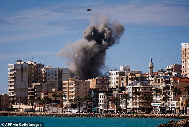 A plume of smoke and a fragment of concrete rise from the site of an Israeli airstrike on the eastern outskirts of Tyre, in southern Lebanon, on March 24, 2026