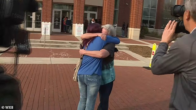 The two then shared a long, tight embrace during which Hundley Smith was seen stroking her daughter's hair before they headed into the courthouse together