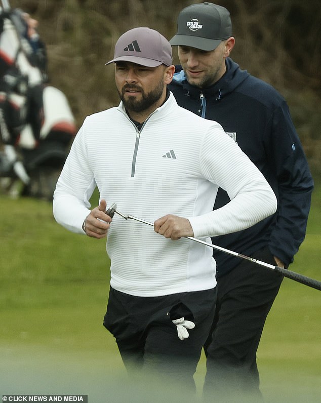 Decked out in Adidas the footballer wore a white top and black trousers, completing the look with a pale purple baseball cap