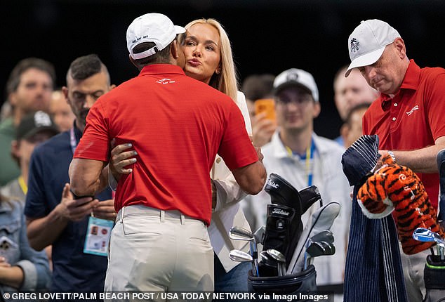 Woods kisses girlfriend Vanessa Trump on the cheek on his return to golf on Tuesday night