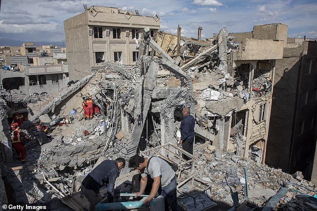 Residents and emergency workers shift through rubble after an airstrike hit a building in Tehran, Iran. President Donald Trump's military action will hit a month tomorrow