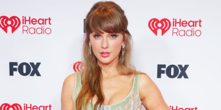 Taylor Swift makes history as she sweeps the board at iHeartRadio Awards alongside Travis Kelce