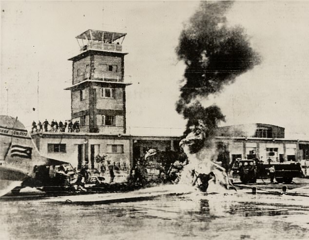 A Cuban airliner is pictured ablaze during the failed Bay of Pigs invasion in 1961
