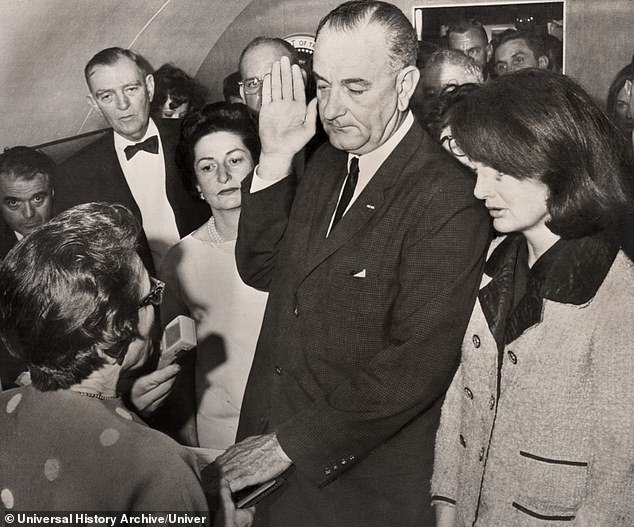 Lyndon Johnson being sworn in as President by Judge Sarah Hughes aboard Air Force One after assassination of President John F. Kennedy,
