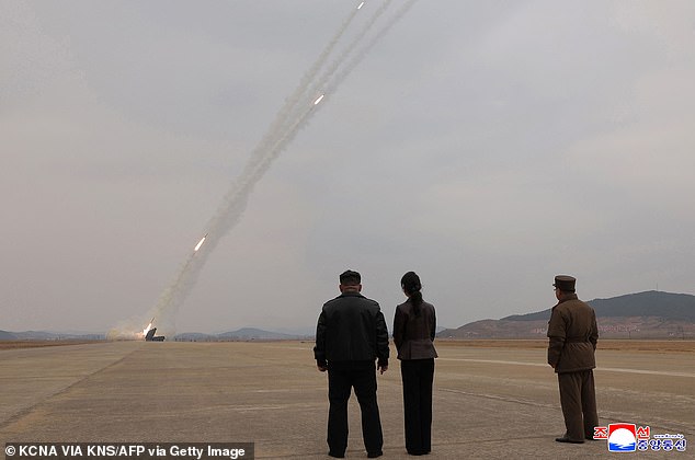 Pictured: The pair observe a training exercise using the North Korean Army's rocket launchers at an undisclosed location in North Korea last month