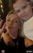 A young woman and a girl posing for a selfie.