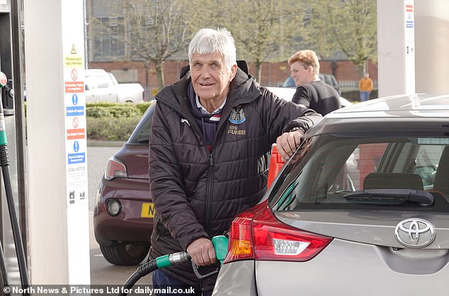 Michael Hall, a 73-year-old retired electrician from Kingston Park, Newcastle, refills his car's tank in Gateshead on Friday